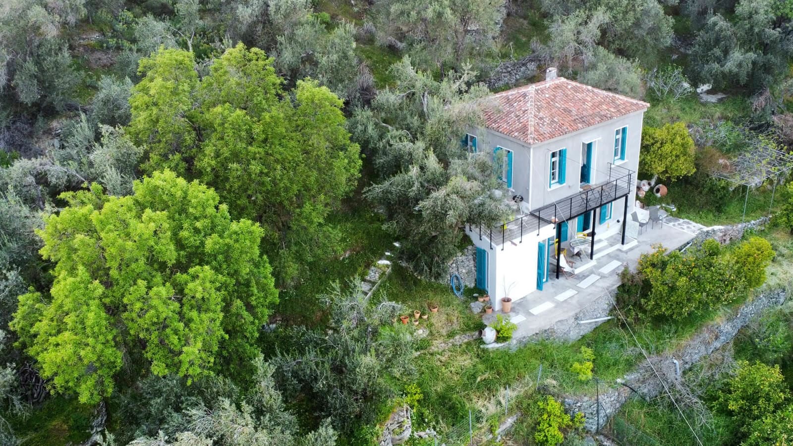 Escape to authentic island tranquility with this beautiful Lesvos rental villa, part of the exclusive Secret Greek Escape collection. Surrounded by olive groves and lush greenery, this charming stone villa features traditional architecture with vibrant blue shutters and a cozy outdoor terrace perfect for relaxing or dining under the Mediterranean sun. Ideal for travelers looking to immerse themselves in the natural beauty and peaceful lifestyle of Lesvos, this rental villa offers a perfect blend of rustic charm and modern comfort. Book your unforgettable Greek island getaway today with Secret Greek Escape.