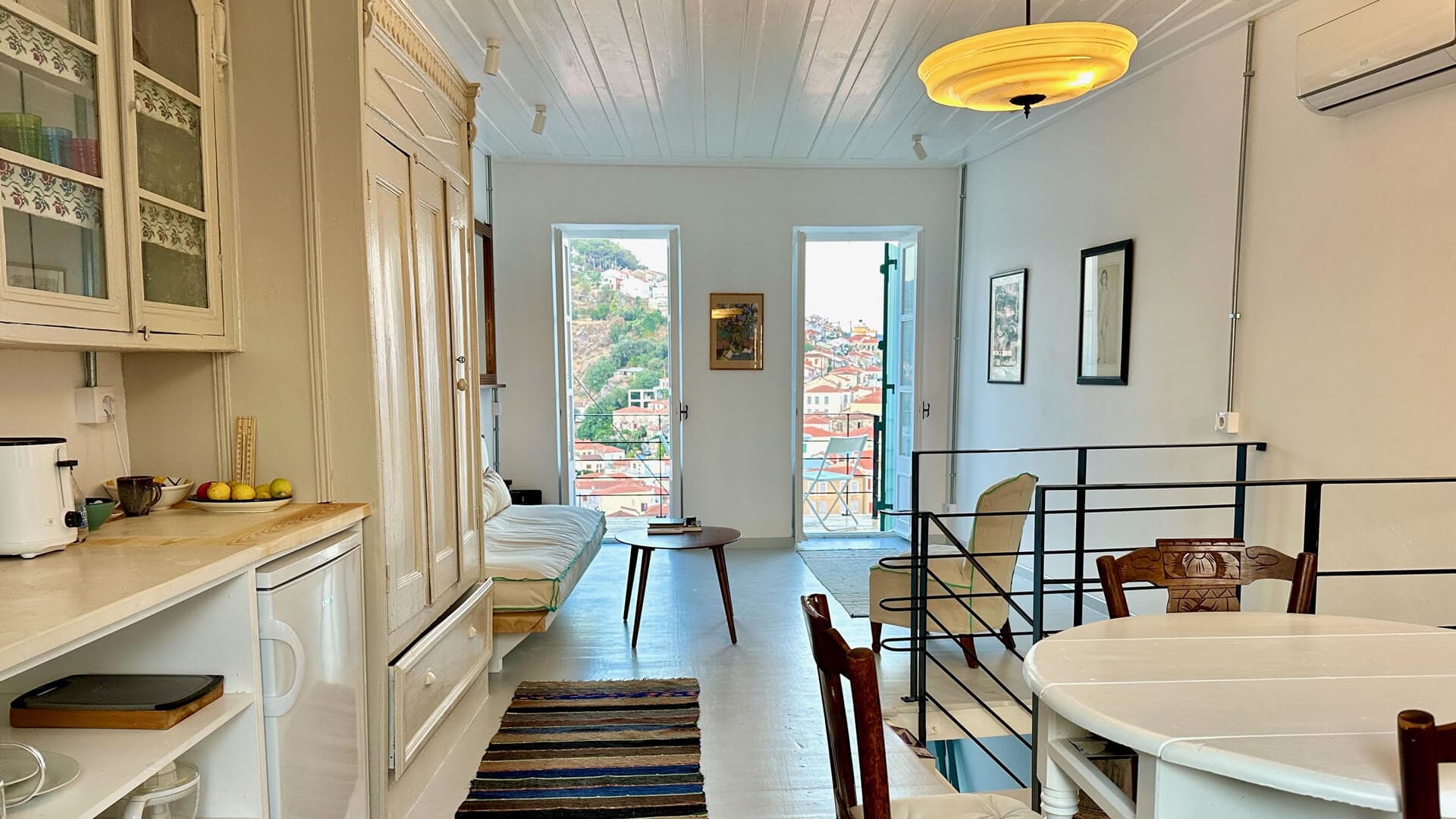 Plomari, Lesvos luxury villa rental: bright main room with romantic four-poster bed, modern amenities and balcony for the ultimate Greek island getaway.